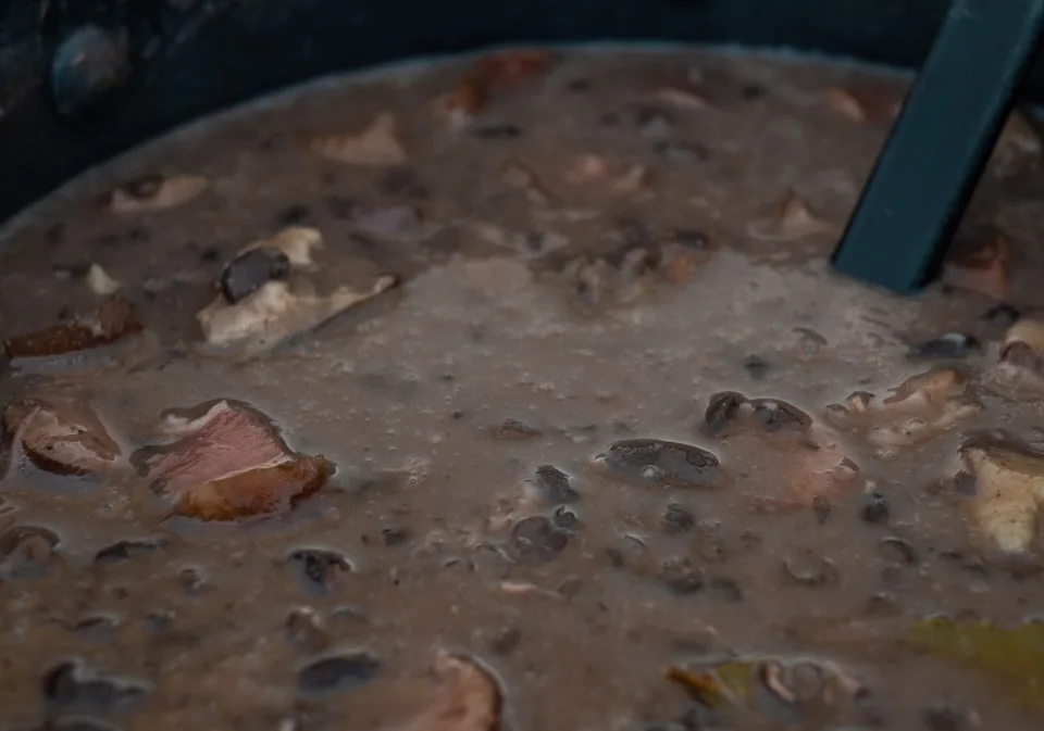 A traditional Brazilian feijoada meal served with rice and side dishes