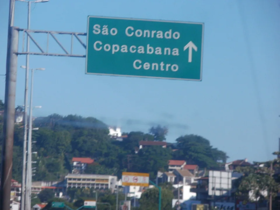 Portuguese road sign pointing toward São Conrado, Copacabana and Centro in Rio de Janeiro